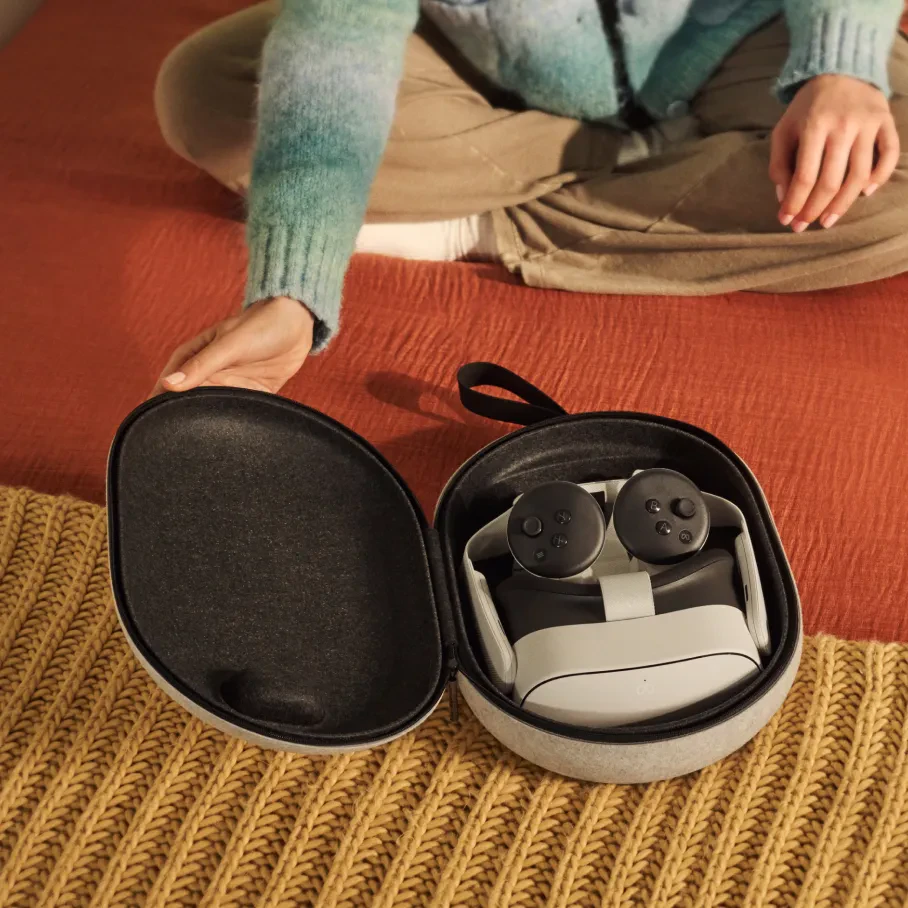 Meta Quest Compact Carrying Case open with headset and controllers on a rug